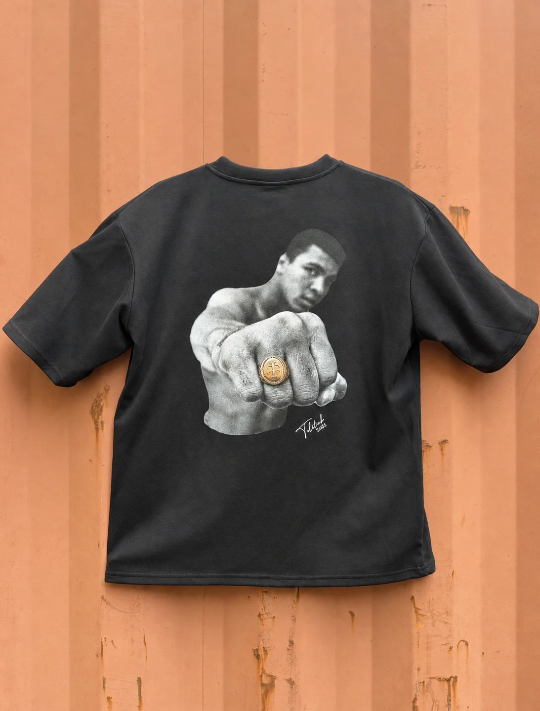 Oversized photoreal halftone portrait screen printed across the back of a heavyweight black tee